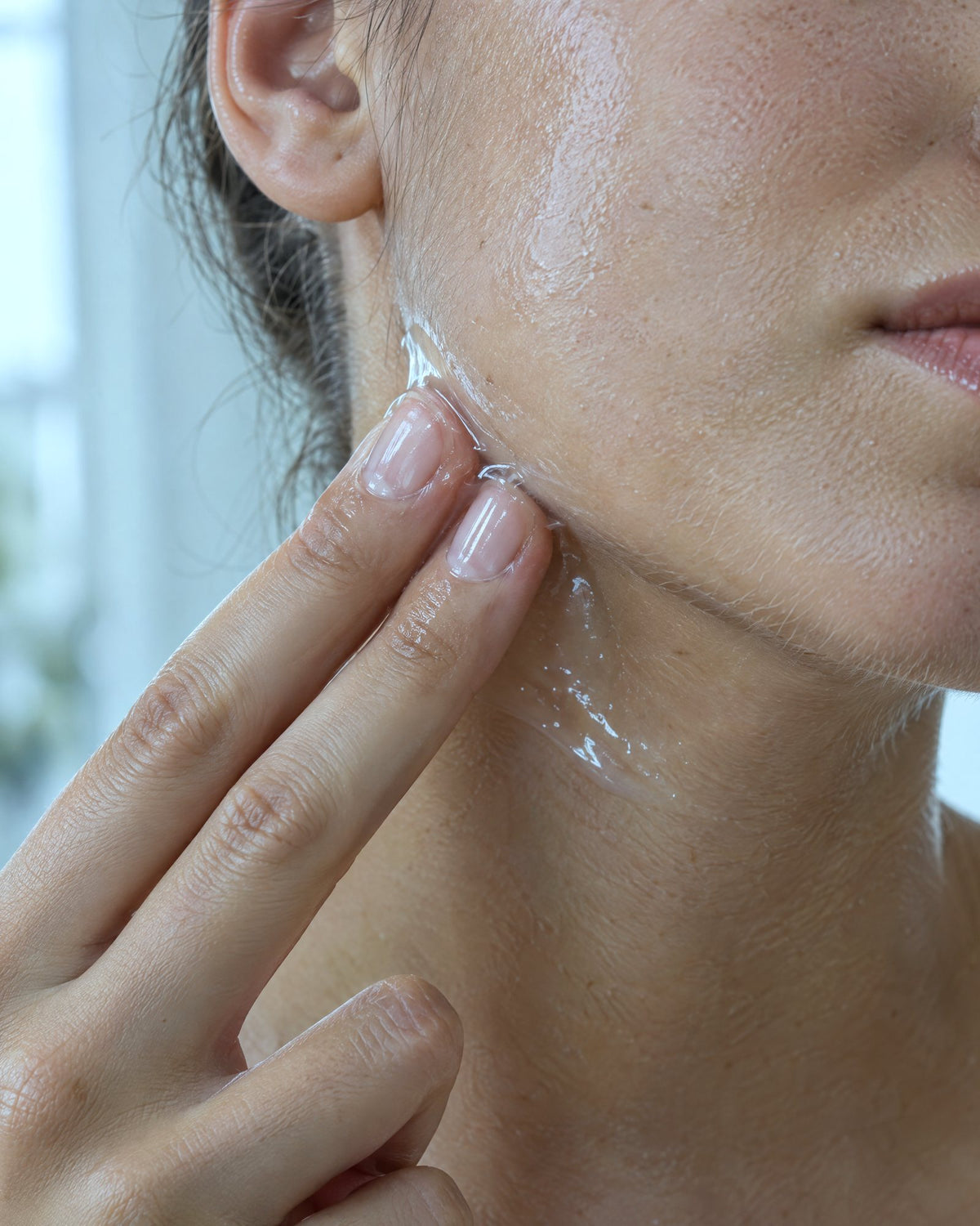 A thin layer of clear gel on the side of the neck and along the jaw.