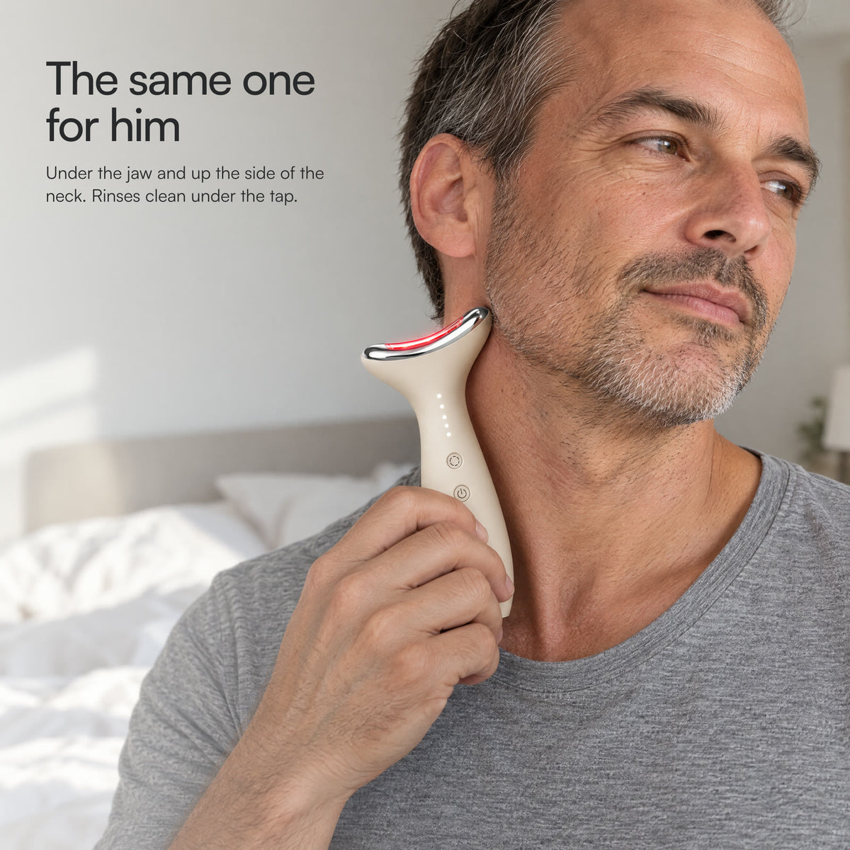 A man in a bedroom gliding Loomi Glide along the side of his neck: the same device for him.